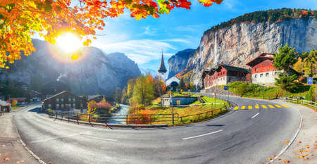 Gorgeous autumn landscape of  alpine village Lauterbrunnen with famous church and Staubbach waterfall. Location: Lauterbrunnen village, Berner Oberland, Switzerland, Europe.の写真素材