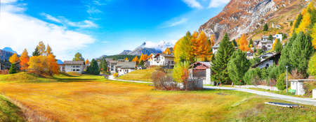 Awesome autumn scene in Maloja village  on the shore of Sils lake(Silsersee). Location: Maloya, Engadine region, Grisons canton, Switzerland, Europe.の写真素材