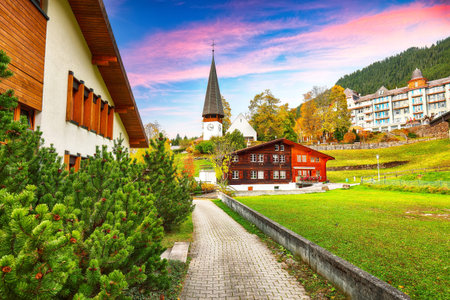 Awesome autumn view of picturesque alpine village Wengen. Sunny morning scene of Swiss Alps. Location: Wengen village, Berner Oberland, Switzerland, Europe.の写真素材