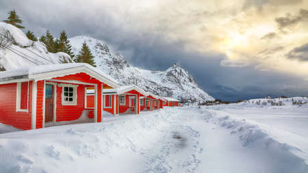 Dramatic winter scenery with traditional Norwegian red wooden houses on the shore of Rolvsfjord on Vestvagoy island at Lofotens. Location: Vestvagoy, Rolvsfjord, Lofotens, Norway, Europe.の写真素材