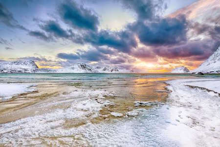 Fabulous winter scenery with Haukland beach during sunset and snowy mountain peaks near Leknes. Location: Leknes, Vestvagoy, Lofotens, Norwayの写真素材