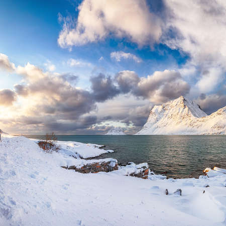 Stunning winter view of Vik beach during sunset with lots of snow and snowy mountain peaks near Leknes. Location: Leknes, Vestvagoy, Lofotens, Norwayの写真素材