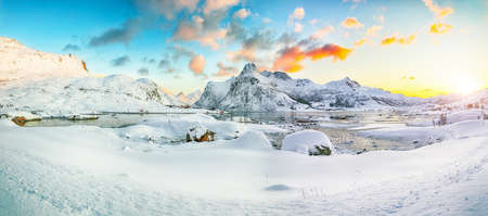 Fantastic frozen Flakstadpollen and Boosen fjords and reflection in water during sunrise with Hustinden mountain on background. Location: Flakstadoya island, Lofoten; Norway, Europeの写真素材