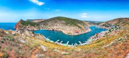 Panoramic view of Balaklava bay with yachts and ruines of Genoese fortress Chembalo in Sevastopol city from the height. Crimeaの写真素材