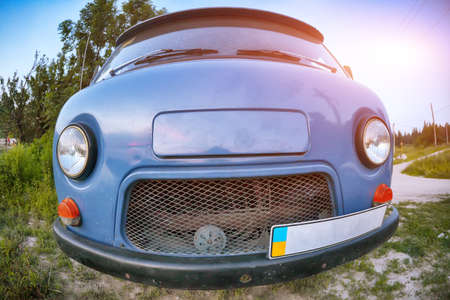 Front-side view of a car on nature background. Fisheye shootの写真素材