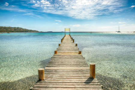 Astonishing landscape with wooden pier on Santa Giulia beach.. Picturesque seascape of Mediterranean sea. Location: Santa Giulia, Porto-Vecchio, Corsica, France, Europeの写真素材