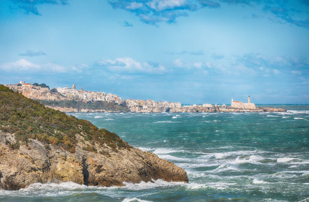 Above the cliffs at the coastline of Vieste. Summer rocky sea coast near Architello (Arch) of San Felice on the Gargano peninsula, Puglia, Italyの写真素材