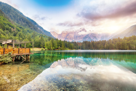 Incredible view of sunset over Fusine lake with Mangart peak on background. Popular travel destination of Julian Alps. Location: Tarvisio comune , Province of Udine, Italy, Europeの写真素材