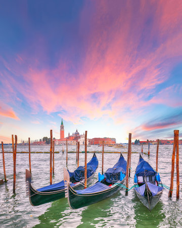 Captivating  landscape with Church of San Giorgio Maggiore on background and gondolas parked beside the Riva degli Schiavoni in Venice. Location: Venice, Veneto region, Italy, Europeの写真素材