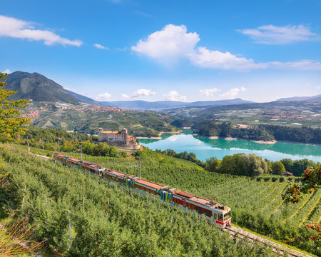 Fabulous  View of the Cles Castel, the Santa Giustina Lake and lots of apple plantations. Location: Cles, Trentino-Alto Adige region, Italy, Europeの写真素材