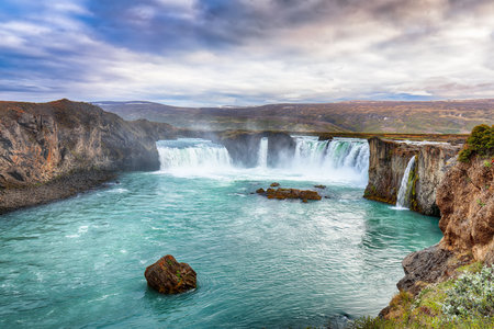 Breathtaking landscape scene of powerful Godafoss waterfall. Dramatic sky over Godafoss. Location: Bardardalur valley, Skjalfandafljot river, Iceland, Europeの写真素材