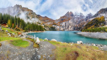 Incredible autumn view of Oeschinensee Lake. Scene of Swiss Alps with Bluemlisalp summit on background. Location: Oeschinen valley, Canton of Bern, Switzerland, Europeの写真素材