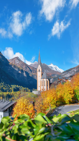 Astonishing autumn landscape  at Heiligenblut with St Vincent Church near Grossglockner mount . Popular travel destination.  Location:  Heiligenblut , Carinthia state,  Spittal an der Drau district,  Austriaの写真素材