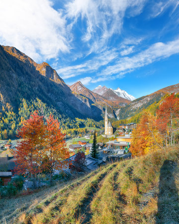 Amazing autumn landscape  at Heiligenblut with St Vincent Church near Grossglockner mount . Popular travel destination.  Location:  Heiligenblut , Carinthia state,  Spittal an der Drau district,  Austriaの写真素材