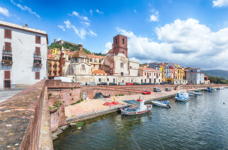 Attractive cityscape of Bosa town with Ponte Vecchio bridge across the Temo river. River embankment with colorful  houses. Location:  Bosa town, Province of Oristano, Italy, Europeの写真素材