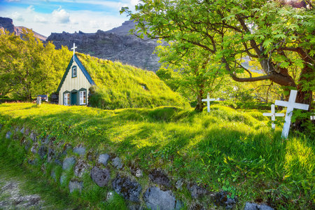 Impressive view of turf-top church Hofskirkja during sunset. Location: village of Hof, Skaftafell, Vatnajokull National Park, Europe.の写真素材