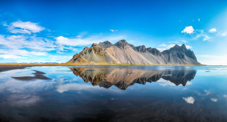 Amazing  sunny day and gorgeous reflection of Vestrahorn mountaine on Stokksnes cape in Iceland. Location: Stokksnes cape, Vestrahorn (Batman Mount), Iceland, Europe.の写真素材