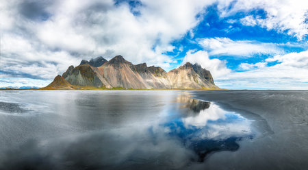Amazing  sunny day and gorgeous reflection of Vestrahorn mountaine on Stokksnes cape in Iceland. Location: Stokksnes cape, Vestrahorn (Batman Mount), Iceland, Europe.の写真素材
