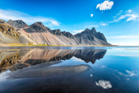 Impressive  sunny day and gorgeous reflection of Vestrahorn mountaine on Stokksnes cape in Iceland. Location: Stokksnes cape, Vestrahorn (Batman Mount), Iceland, Europe.の写真素材