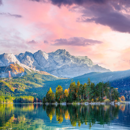 Stunning autumn landscape of Eibsee Lake in front of Zugspitze summit under sunset. Location: Eibsee...