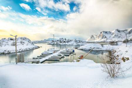 Amazing winter scenery with yachts and boats nier pier in small fishing village and snowy  mountain peaks near Valberg.  Location: Valberg, Vestvagoy, Lofotens, Norwayの写真素材
