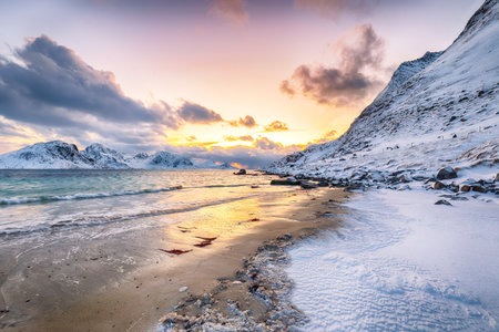Unbelivable  winter scenery with Haukland beach during sunset and snowy  mountain peaks near Leknes.  Location: Leknes, Vestvagoy, Lofotens, Norwayの写真素材