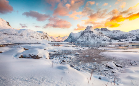Amazing Flakstadpollen and Boosen fjords with cracks on ice during sunrise with Hustinden mountain on background. Location: Flakstadoya island, Lofoten; Norway, Europeの写真素材