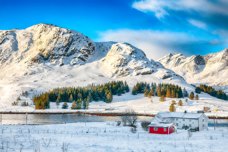 Amazing winter view on Selfjorden with small fishing houses (rorbu) and snowy peaks on background. Location: Flakstadoya island Lofoten; Norway, Europeの写真素材