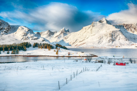 Amazing  winter view on Selfjorden with small fishing houses (rorbu) and snowy peaks on background. Location: Flakstadoya island Lofoten; Norway, Europeの写真素材