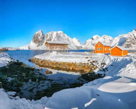 Amazing winter view of Sakrisoy village and snowy mountaines on background. Popular tourist destination on Lofotens.  Location: Sakrisoy , Moskenesoya , Lofoten; Norway, Europeの写真素材
