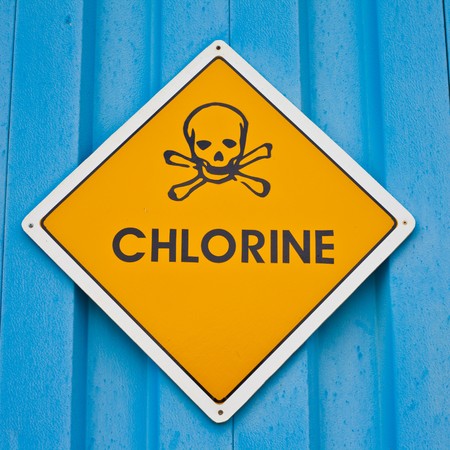 Chlorine warning sign with skull and crossbones on blue background.の写真素材