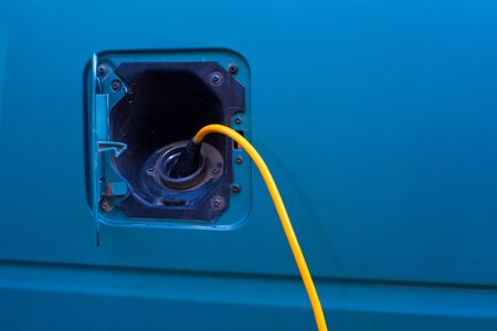 Plug-in electric car being charged.の写真素材