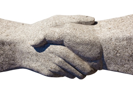 Granite sculpture of shaking hands isolated on white background.の写真素材