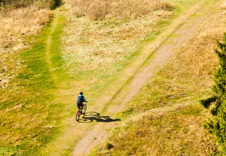 Mountain biker on off-road trail branching off.の写真素材