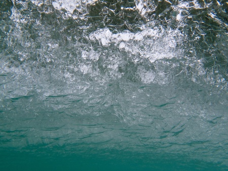 Underwater shot: view of the underside of a thick layer of ice of a frozen lake.の写真素材