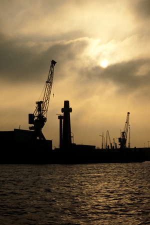 Skyline silhouette of Hamburg harbor, Germany, Europe, against dramatic sky.の写真素材