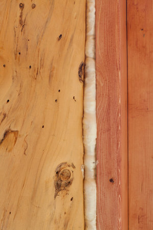 Polyurethane foam seals gap in wooden frame construction conserving energy.の写真素材