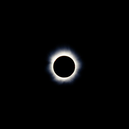 Total solar eclipse with the moon obscuring the disc of the sun so that only the corona is visible as a bright ringの写真素材