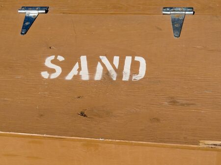 Hinged lid of painted plywood box providing sand to prevent slippage in winter conditions.の写真素材