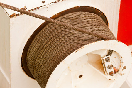 Drum and metal cable or hawser of a mechanical winch used for hoisting or hauling heavy loads