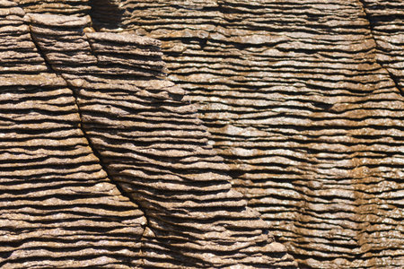 Background texture pattern of eroded cracks between marine sedimentary Pancake Rocks of Punakaiki, New Zealand, close-upの写真素材