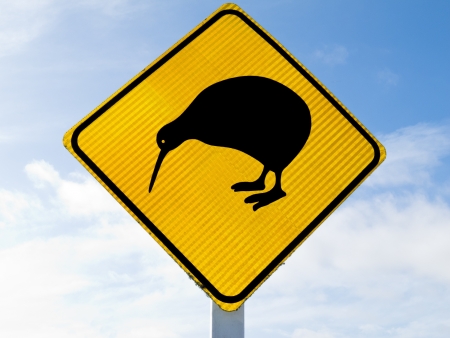 New Zealand Road Sign, Attention Kiwi Crossing against a cloudy blue skyの写真素材