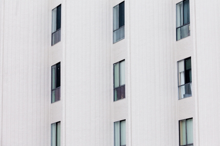 External facade of contemporary residential apartment block development with large glass windows in structured outside wall.の写真素材
