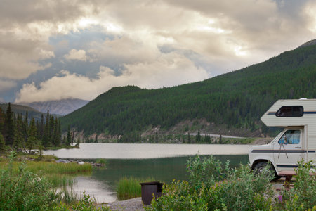 Camper van parked on Summit Lake Campground in Stone Mountain Provincial Park, highest point of the Alaska Highway, northern BC, Canadaの写真素材