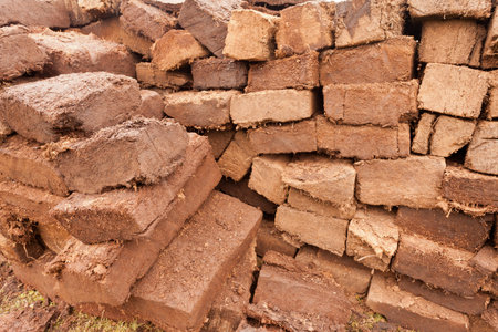 Background pattern abstract of pile of drying stacked bog peat turf briquette cuttings