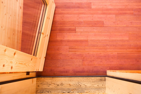 Doorway with open glass door leading onto luxury wooden porch shot from above showing rich wood colors and grain textures of porch hardwood flooringの写真素材