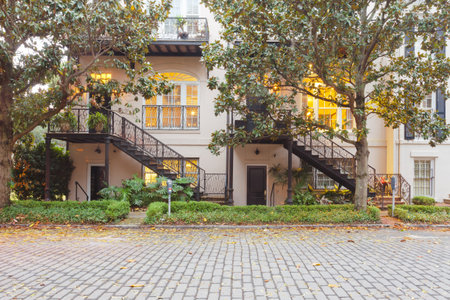 Multiplex apartment home in historic building on cobblestone road of East Harris Street in Historic District of downtown city of Savannah, Georgia, GA, USAの写真素材