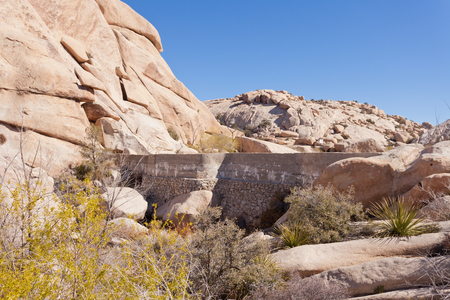 Barker Dam concrete vintage Mojave Desert ranching infrastructure for watering cattle in Joshua Tree National Park, California CA, USAの写真素材