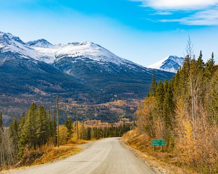 Late autumn fall and snowy mountains 137 km from Dease Lake on Stewart-Cassiar Highway 37 in Northern British Columbia, BC, Canadaの写真素材