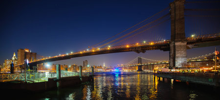 Manhattan Brooklyn bridge East river lights in nighttimeの写真素材